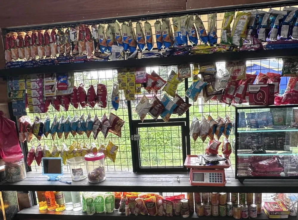 Snacks, drinks and a calculator on the counter of Dell's Sari-Sari Store